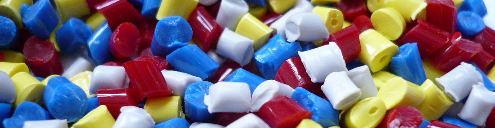 Pile of little pieces of yellow, red, blue and white plastic.