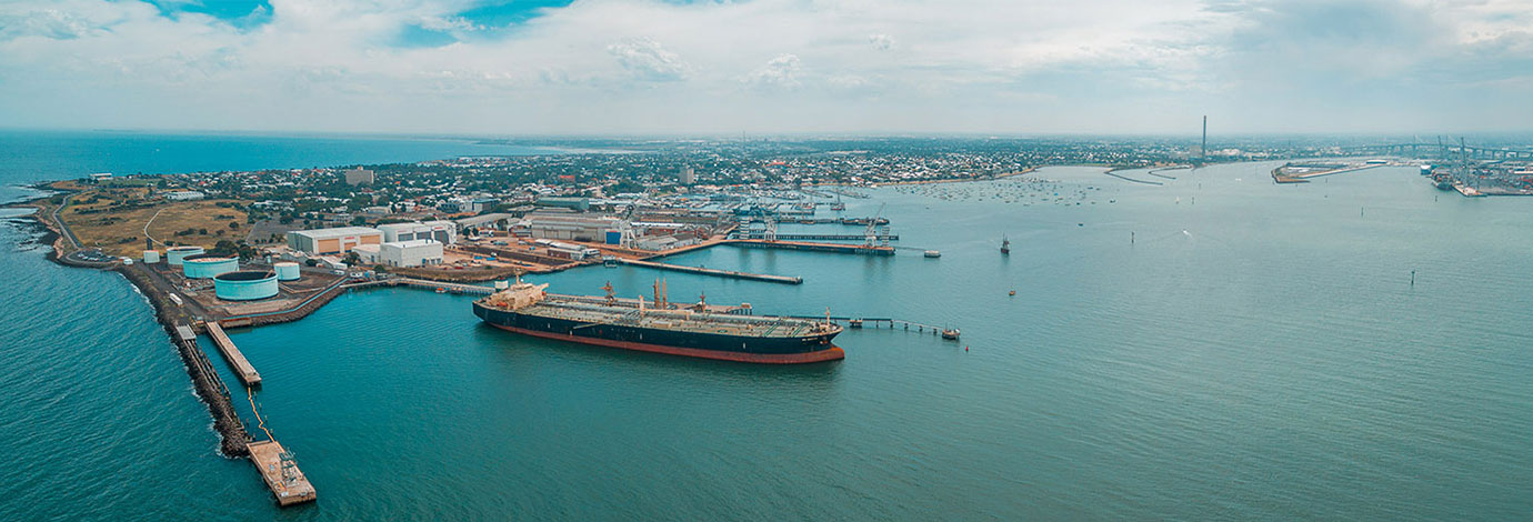 Aerial view of industrial docks and nautical vessel at Yarra river mouth. Williamstown, Melbourne, Australia.